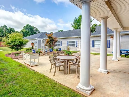 Outdoor patio area with seating and greenery