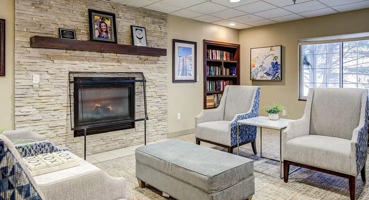 Comfortable living room with a fireplace and seating at The Haven at North Hills.