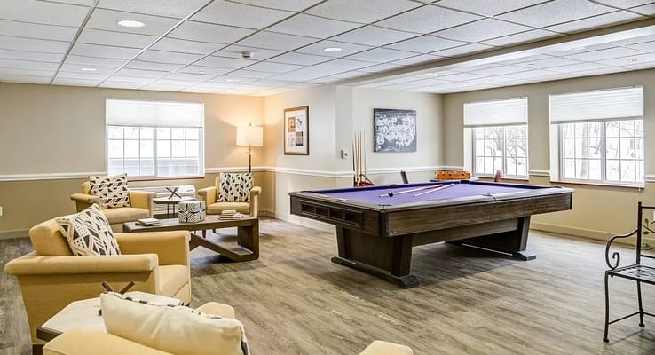 Billiards table and seating area in a senior living facility