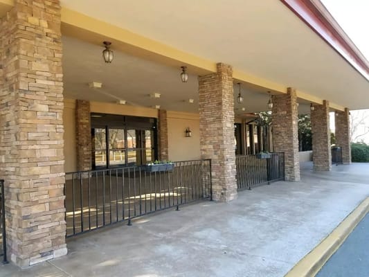 Building entrance with stone columns and lighting