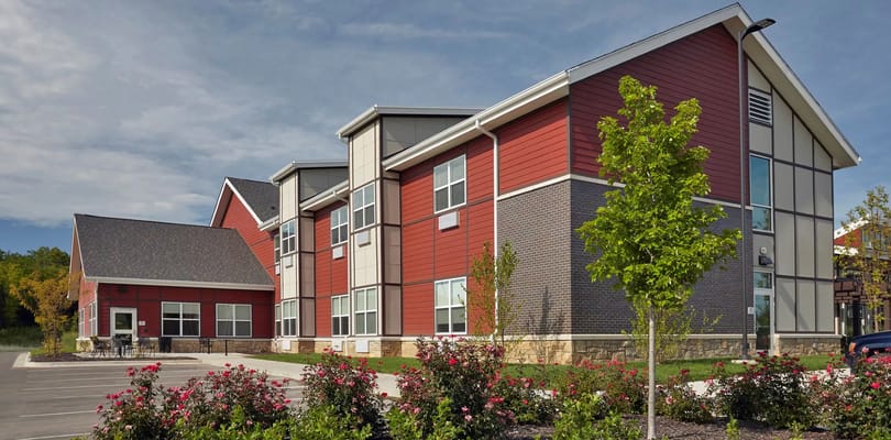 Exterior of The Healthcare Resort showcasing corner of the building with landscaping.