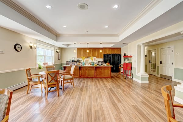 Bright and welcoming common area kitchen with dining seating.