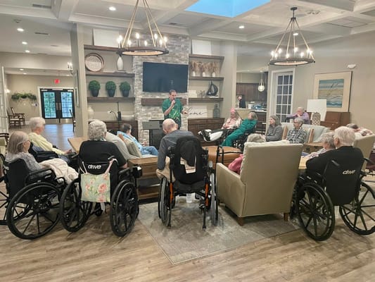 Seniors in wheelchairs attending a group activity in a cozy common area