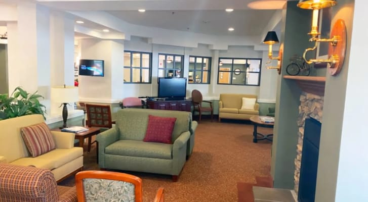 Interior common area with seating and a fireplace