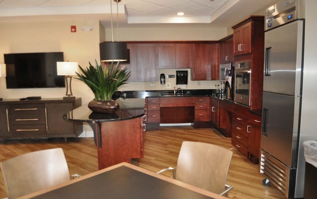 Modern kitchen with dark wood cabinetry and appliances.
