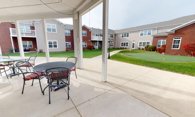 Outdoor patio area with seating and green space