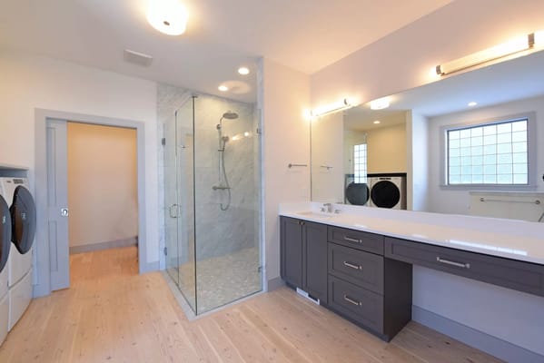 Bright and spacious bathroom with shower and laundry area