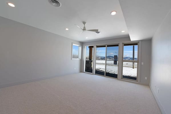 Bright living room showcasing large windows with a view of the snow-covered landscape