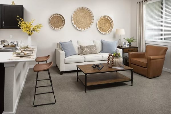 Inviting living room with a sofa, armchair, and decorative elements