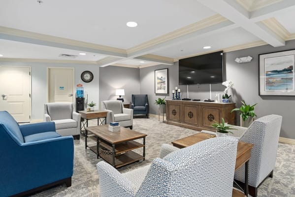 Inviting living room with seating and TV at The Landings at Gentry Park