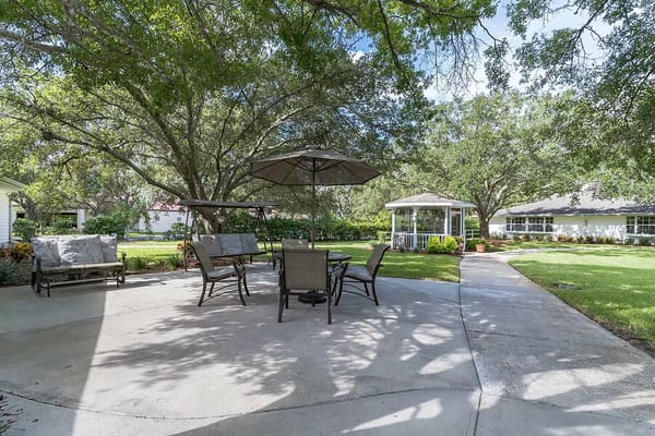 Outdoor seating area with gazebo in a landscaped garden