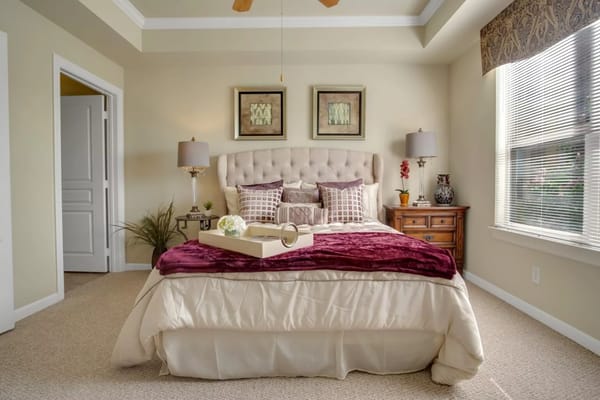 Well-decorated private resident room with bed and decor