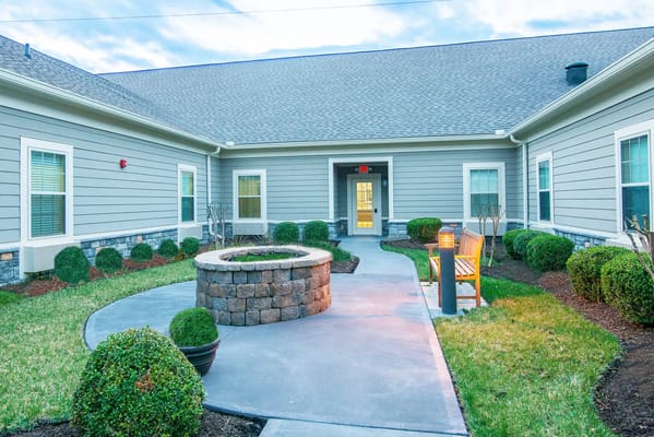 Outdoor courtyard with seating and a stone feature.