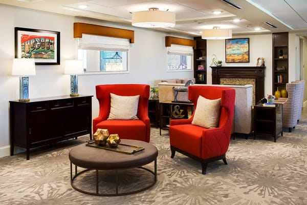 Cozy living room featuring red chairs and decorative lighting