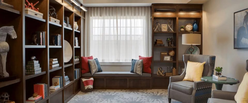 Comfortable living room with bookshelves and seating area