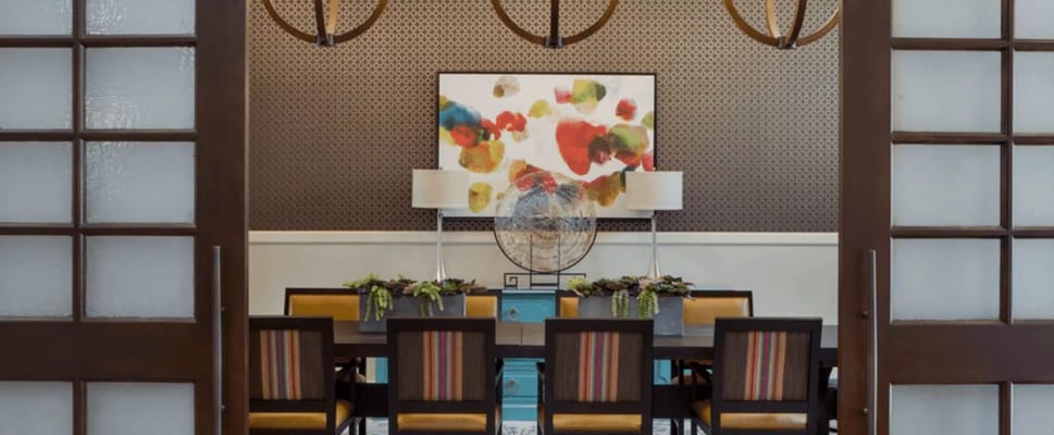 View of the dining room with colorful artwork and modern decor
