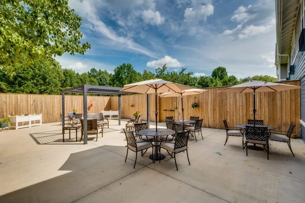 Outdoor patio area with tables and umbrellas