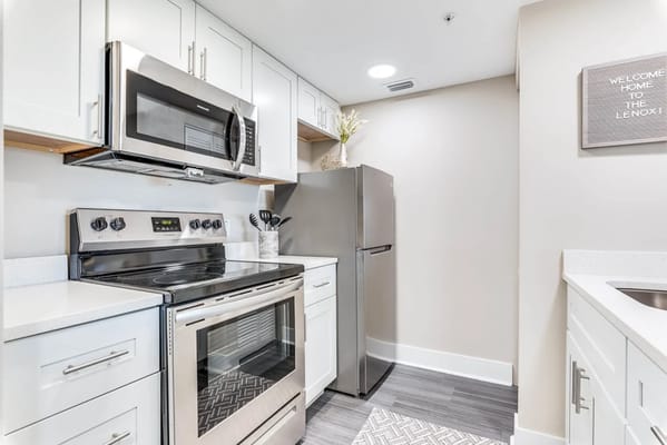 Modern kitchen with stainless steel appliances and white cabinetry