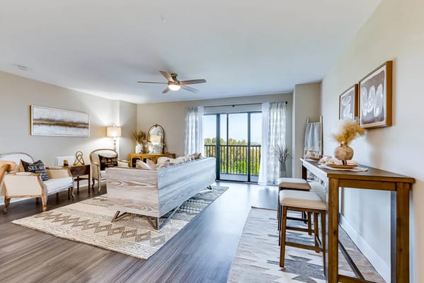 Modern living room with sofa and balcony view at The Lenox At Merritt Island.