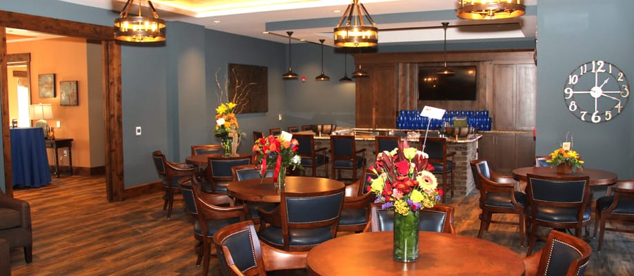 Spacious common area with dining tables and floral arrangements