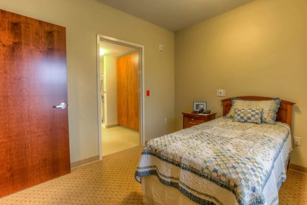 Cozy resident room with a bed and a door