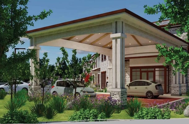 Modern entrance of senior living facility with lush landscaping