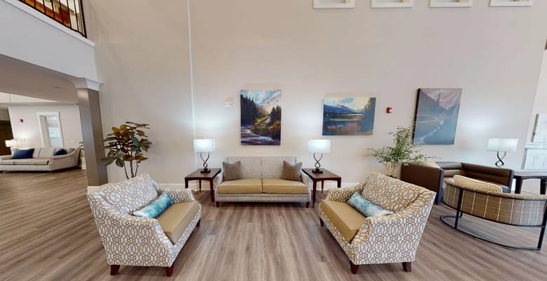 Seating area in the lobby of The Lodge at Stephens Lake, featuring couches and artwork.