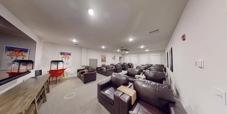 Cozy lounge with leather seating and popcorn cart