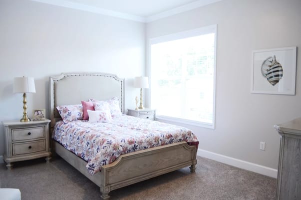 Brightly decorated room with a floral bedspread