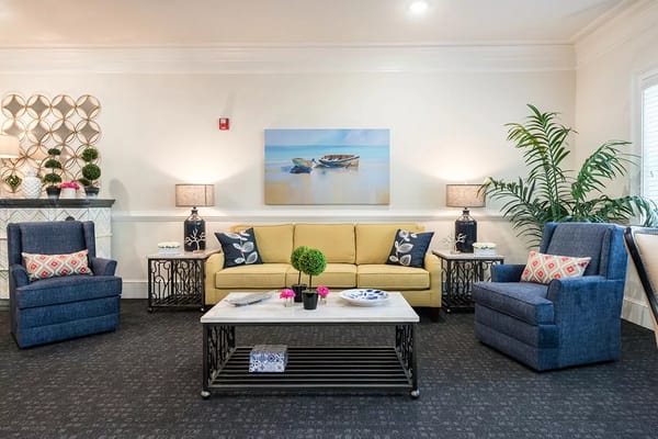 Cozy living room with yellow couch and blue chairs