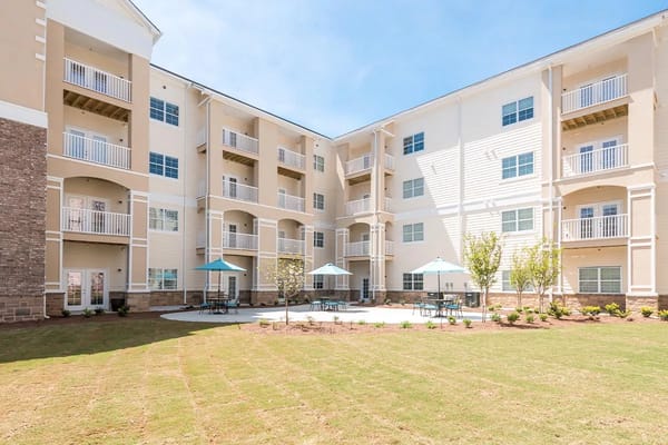 View of the courtyard with seating areas and balconies at The Mansions at Decatur.