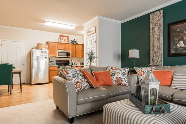 Comfortable living room with sofa and kitchen visible