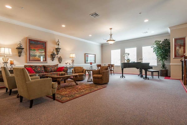 Cozy lounge area with seating and a piano