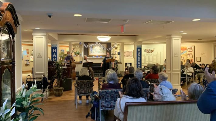 Residents enjoying a musical performance in a common area