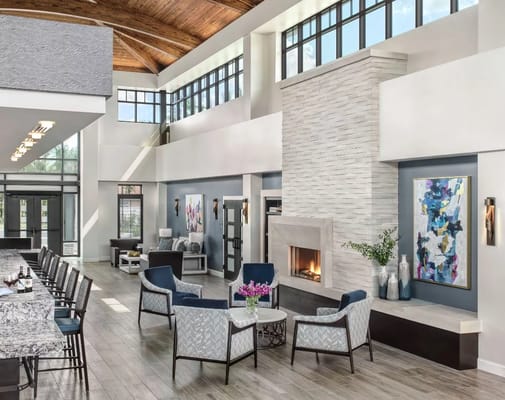 Bright common area with seating and fireplace