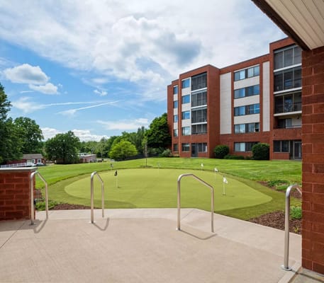 View of the outdoor putting green and building exterior