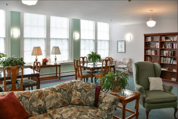 Bright common area with comfortable seating and bookshelves