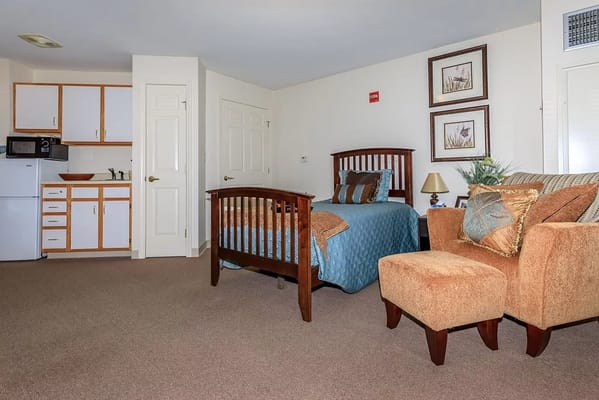 Interior view of a studio apartment with kitchenette and seating area.