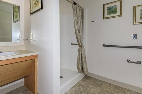 Accessible bathroom featuring a shower and grab bars