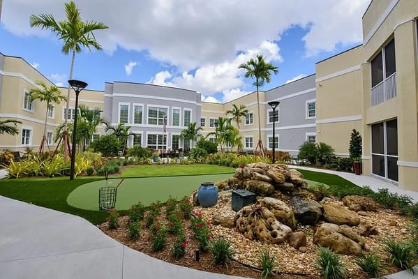 Well-maintained courtyard with tropical plants and seating areas