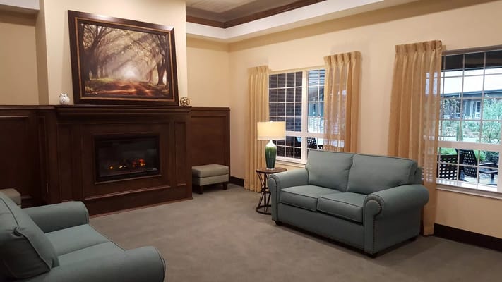 Comfortable living room with blue sofas and fireplace