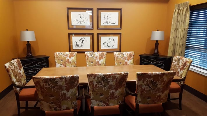 Cozy meeting room with floral chairs and horse artwork