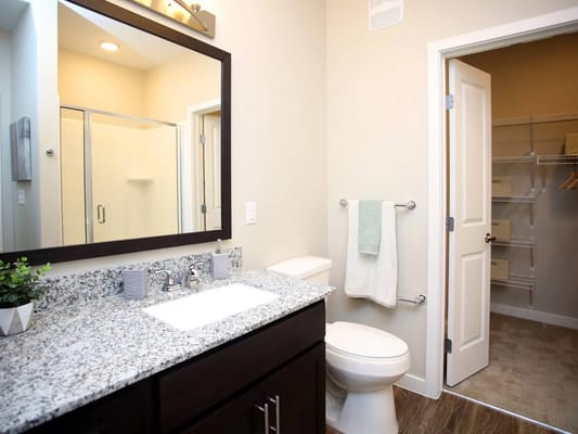 Spacious bathroom with granite countertop and shower