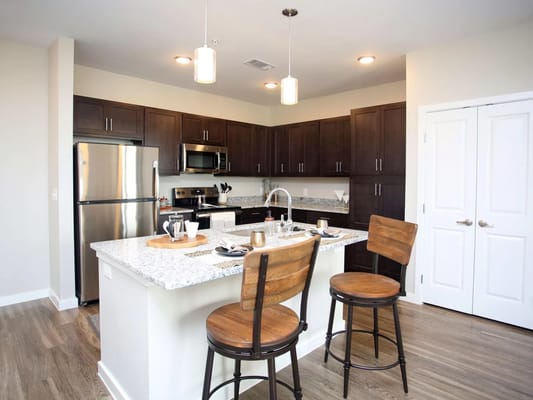 Modern kitchen with granite countertop and seating