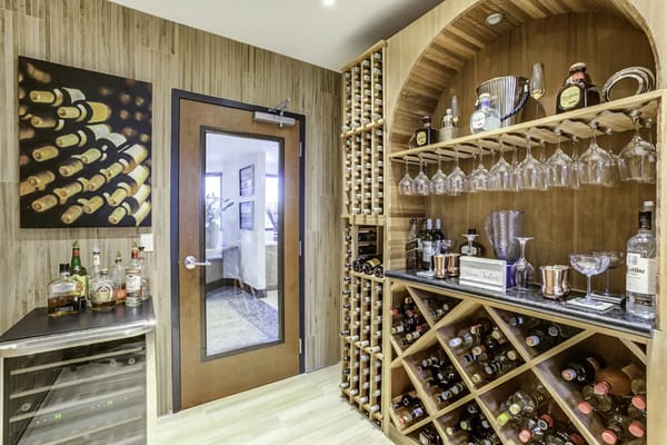 A well-stocked wine cellar featuring a variety of bottles and glasses.
