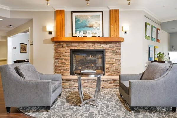 Cozy common area with chairs and fireplace