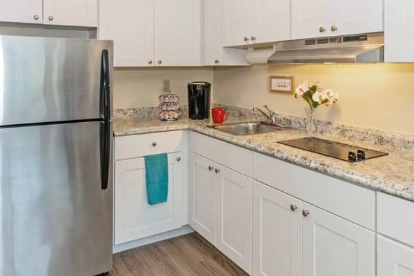 Modern kitchen with stainless steel appliances and granite countertops