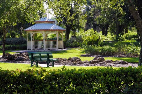 Gazebo surrounded by greenery in a park setting