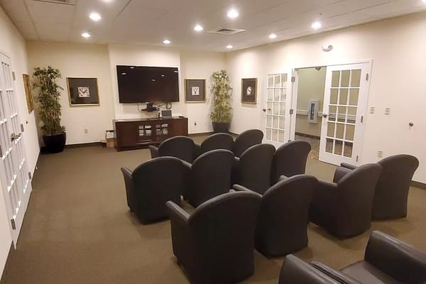 Interior view of a common area with seating and a TV