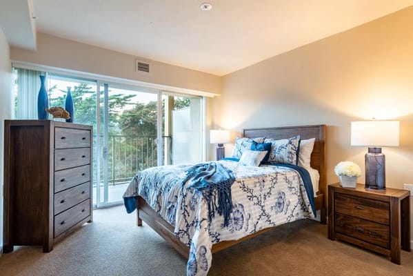 Comfortable bedroom with a bed, dresser, and natural light